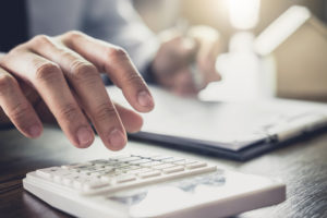 Estate Planning Lawyer St. Charles MO - Businessman or lawyer accountant working financial investment on office, using calculator analysis finance document report real estate and home loan insurance.