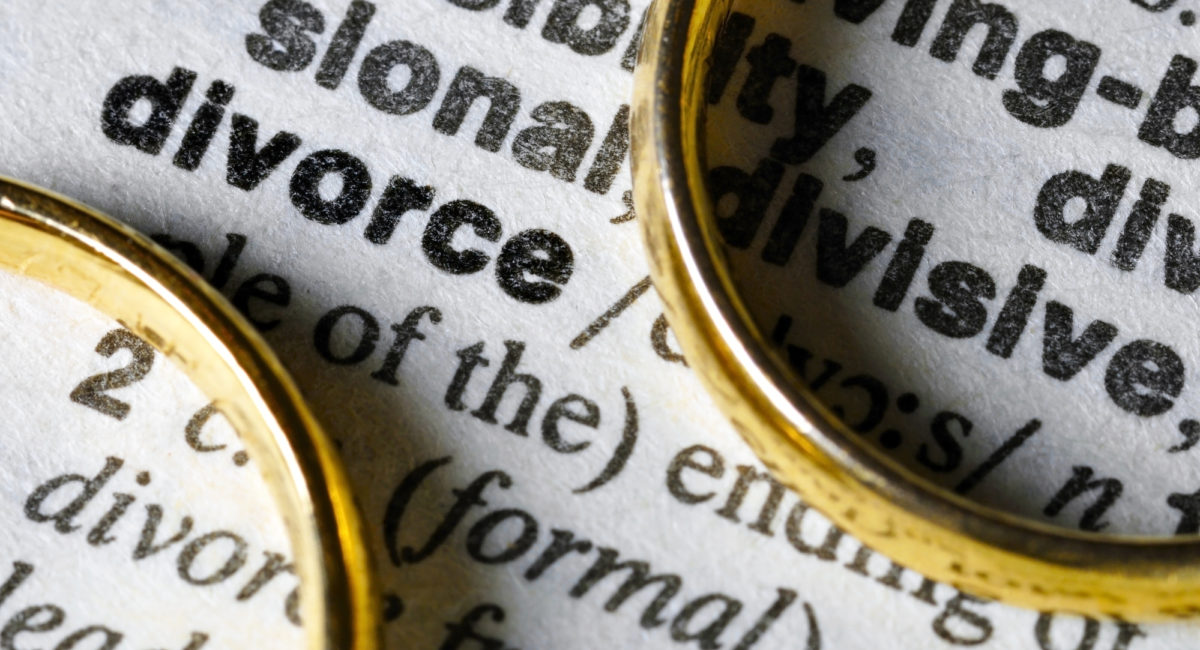 3 Common Questions Regarding Divorce - Two separate wedding rings next to the word